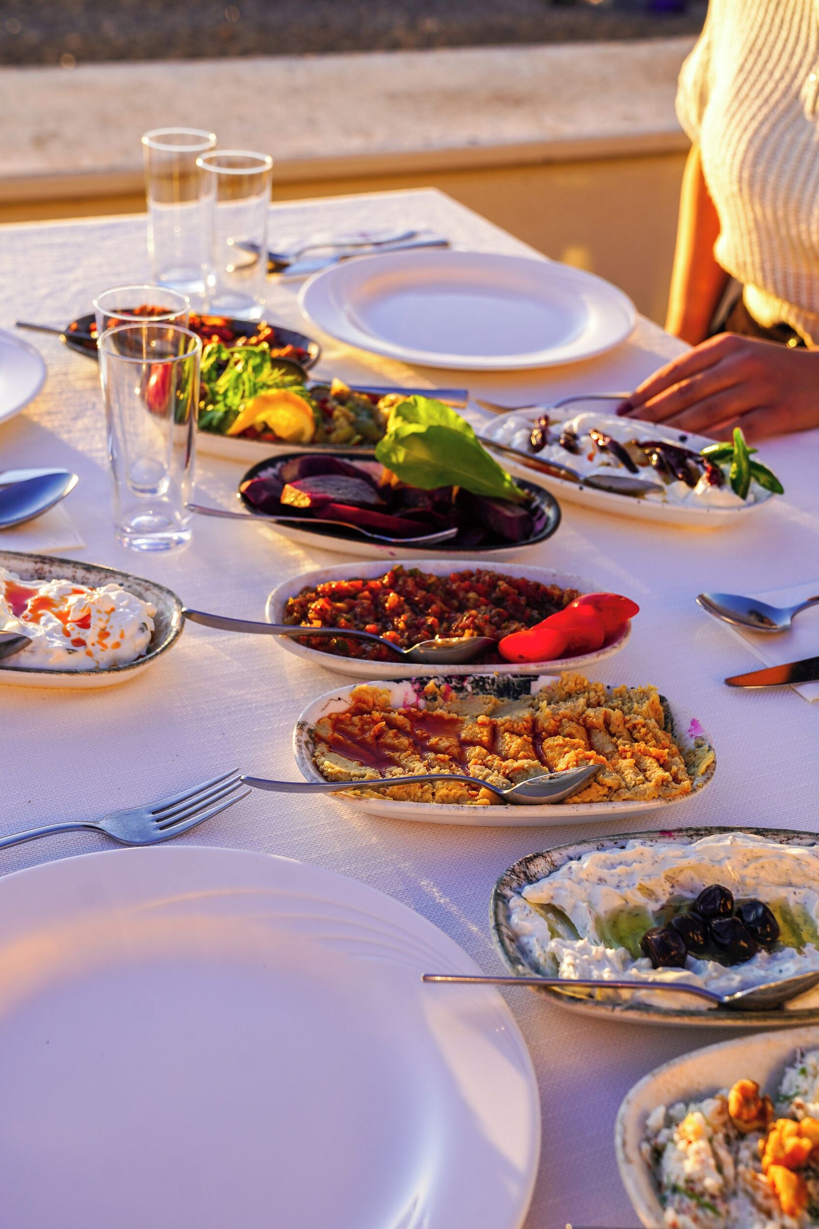 A table set for a meal with various dishes and utensils.