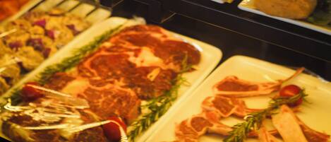 A buffet with various food items including bread, salads, and meats.