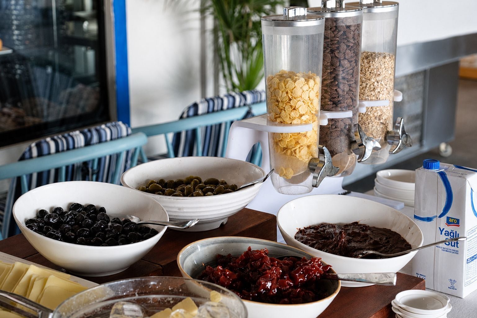 A buffet table with various food items and containers.