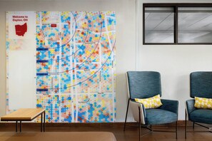 A map with street names and walking times, two chairs, and a small table. - Marriott TownePlace Suites Dayton North (Dayton)