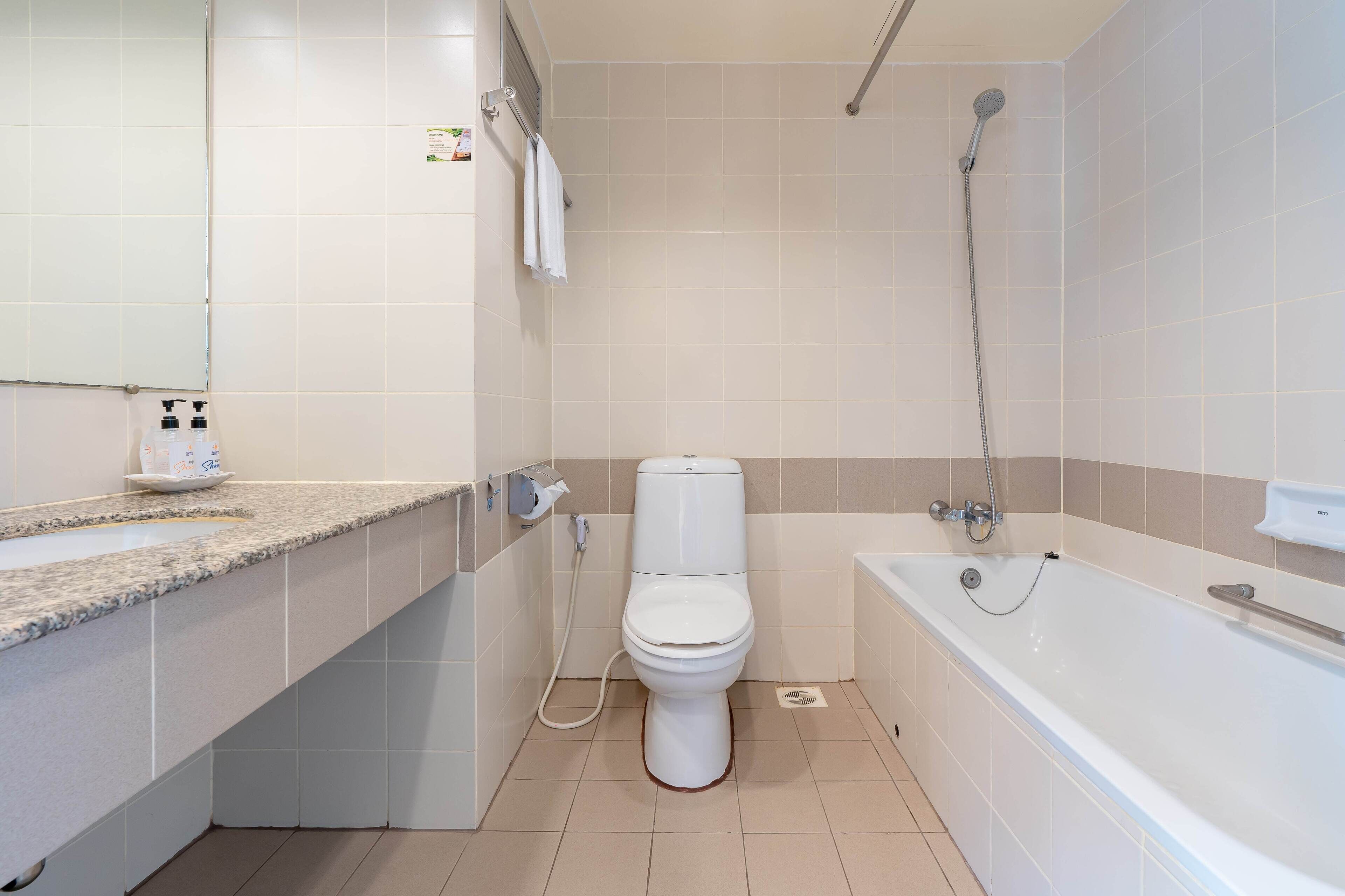 A bathroom with a toilet, sink, and bathtub.
