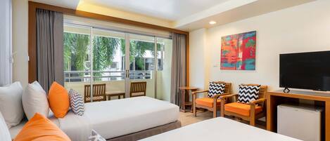 A hotel room with two beds, a TV, a small table, and a window with curtains.