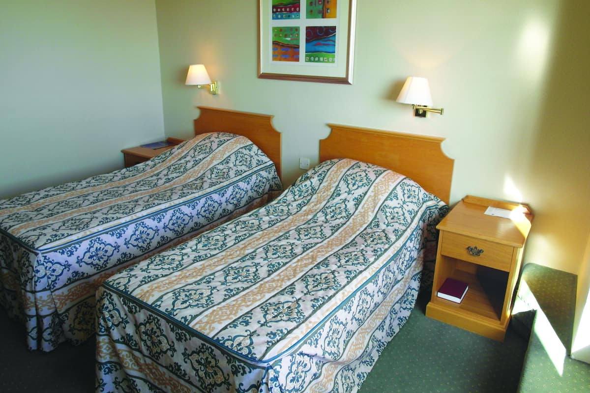Desk, iron/ironing board, bed sheets