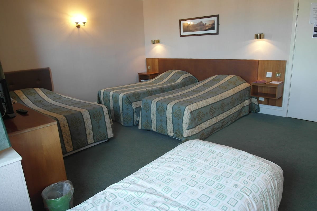 Desk, iron/ironing board, bed sheets