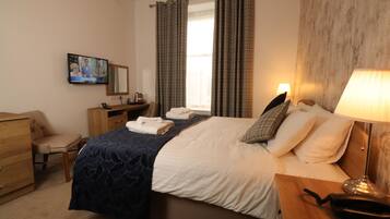 Desk, iron/ironing board, bed sheets