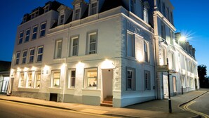 A historic building with multiple stories, large windows, and a sign indicating it is a hotel. - The Lakeland Kendal Hotel, Sure Hotel Collection by BW (Kendal)
