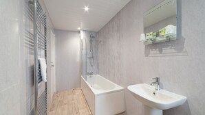 A modern bathroom with a glass-enclosed shower, a freestanding bathtub, and a pedestal sink. - The Lakeland Kendal Hotel, Sure Hotel Collection by BW (Kendal)