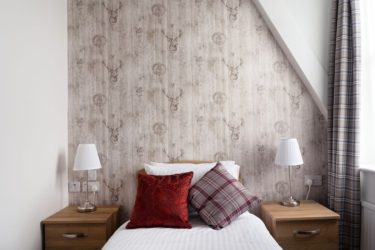 Desk, iron/ironing board, bed sheets