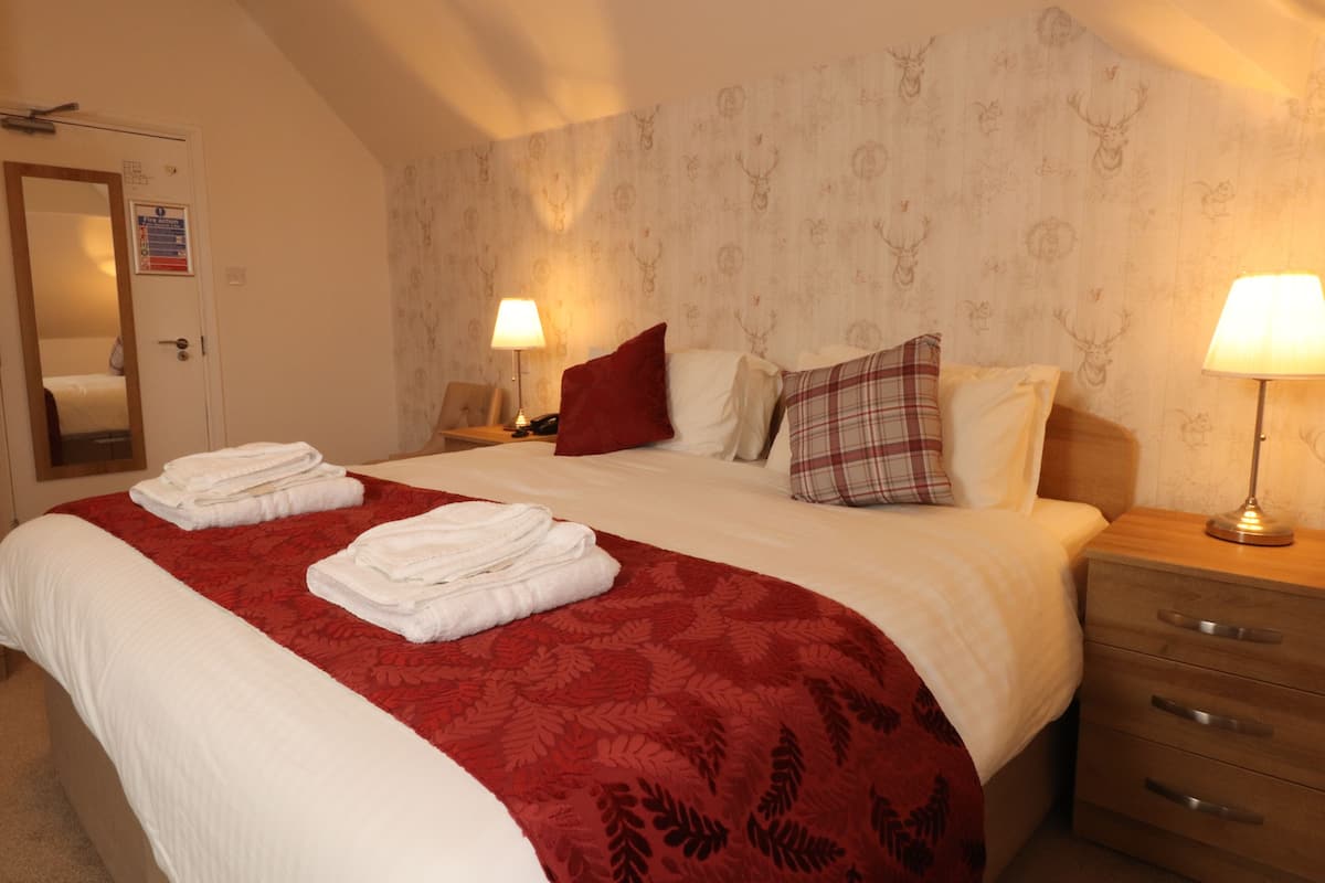 Desk, iron/ironing board, bed sheets