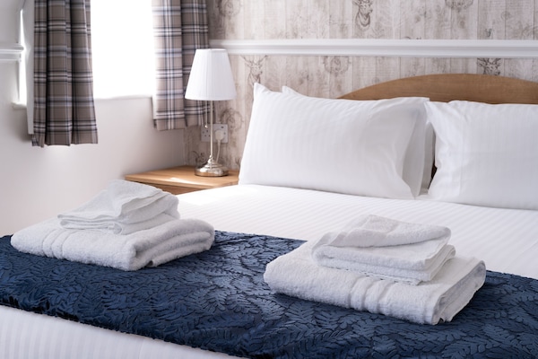 Desk, iron/ironing board, bed sheets