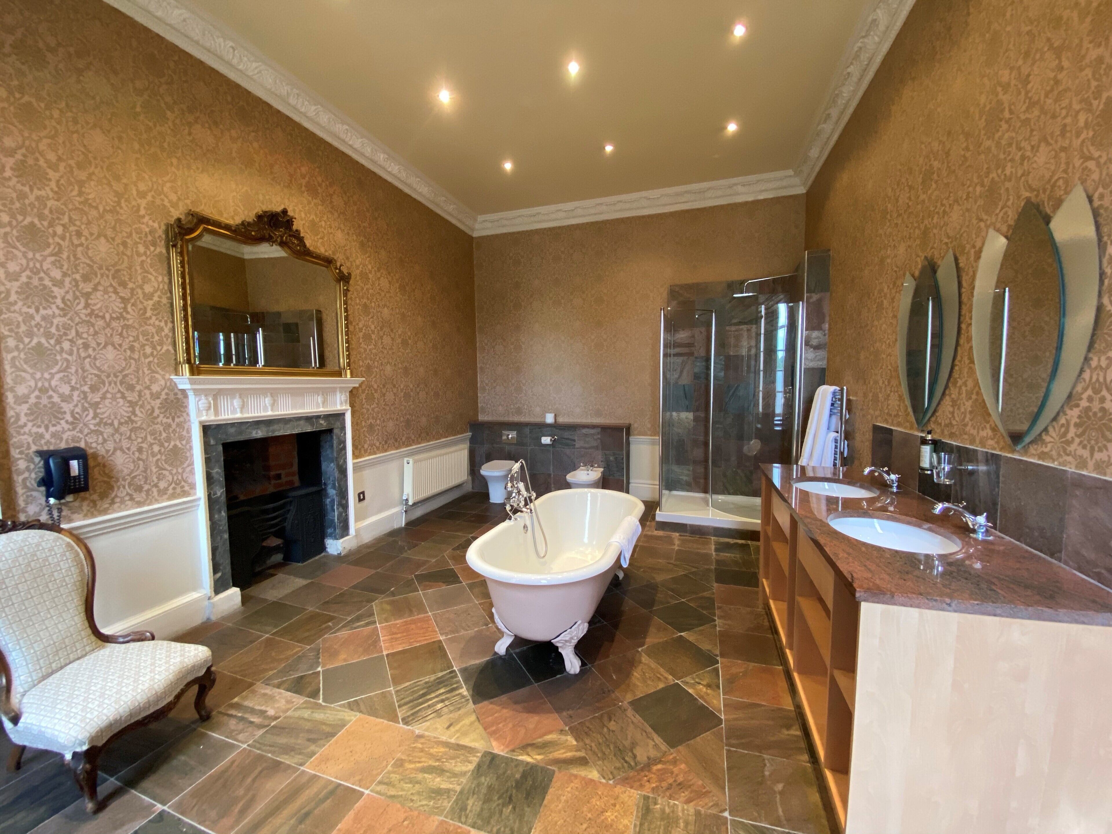 signature suite | bathroom | combined shower/bathtub, deep-soaking bathtub, designer toiletries