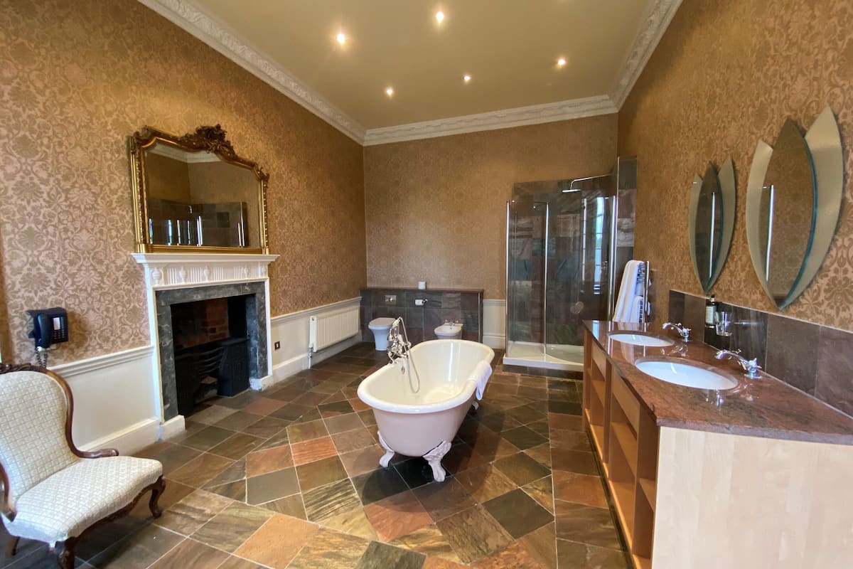 signature suite | bathroom | combined shower/bathtub, deep-soaking bathtub, designer toiletries