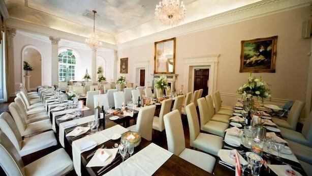 A formal dining room with multiple tables set for service, elegant chandeliers, and classical architecture. - Colwick Hall Hotel (Nottingham)