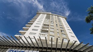 A tall, modern building with a sign for "OAKS ASHIFLE" at the base.