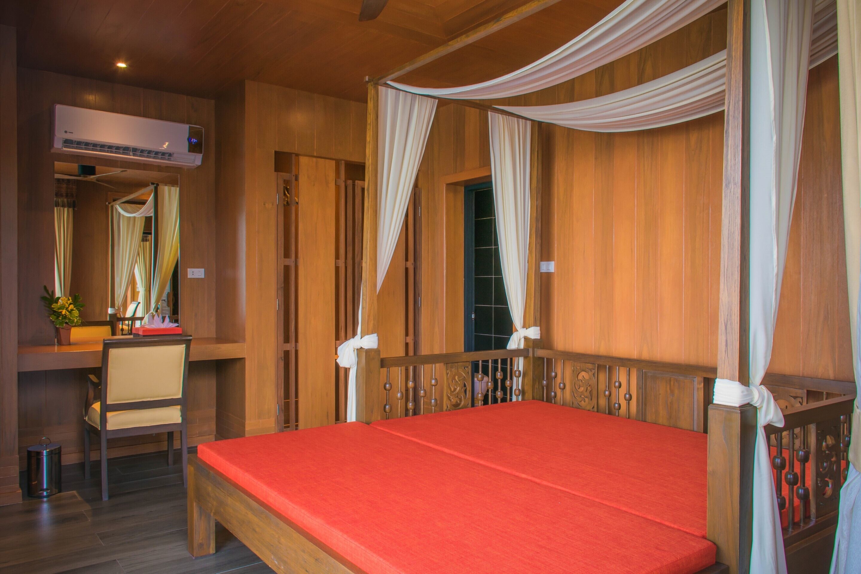 A room with a bed, a desk, and a chair.