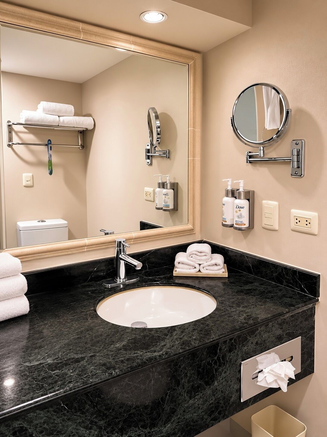 A bathroom with a sink, mirror, towel rack, and toiletries.