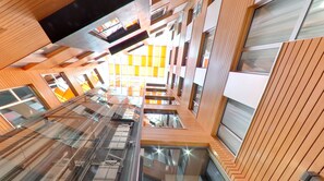 A modern building with multiple floors, large windows, and a central atrium. - Hotel Silken Gran Teatro Burgos (Burgos)