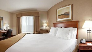 A hotel room with a large bed, a desk with a chair, a lamp, and a painting on the wall. - Holiday Inn Express & Suites Sheldon by IHG (Sheldon)