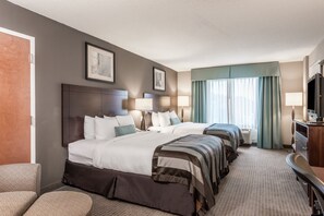 A hotel room with a large bed, a desk, and a television. - Home2 Suites by Hilton St. Charles St.Louis (St. Charles)