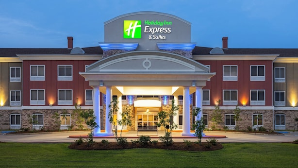 A Holiday Inn Express & Suites hotel with a brick facade, large entrance, and illuminated signage. - Holiday Inn Express Hotel & Suites New Iberia - Avery Island by IHG (New Iberia)