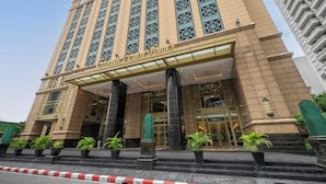 A grand entrance with a prominent sign, large columns, and potted plants. - Grande Centre Point Ratchadamri (Bangkok)
