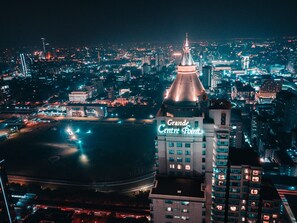 A nighttime cityscape with a prominent building labeled "Grande Centre Point."