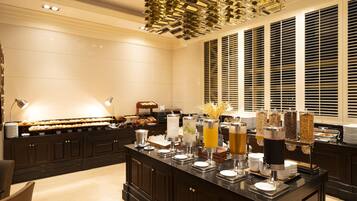 A buffet setup with various food items and beverages.
