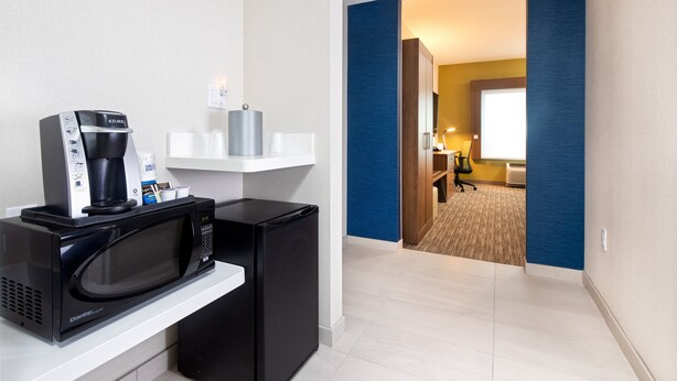 A kitchenette with a microwave, coffee maker, and a small refrigerator. - Holiday Inn Express & Suites Halifax Airport by IHG (Goffs)