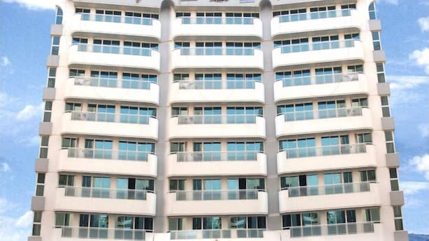 A multi-story hotel with a symmetrical facade, large windows, and a central entrance. - Royal Plaza Hotel Apartments (Dubai)