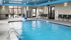 A swimming pool with a clear blue water, surrounded by lounge chairs and a lifeguard stand. - Hampton Inn & Suites Toledo-Perrysburg (Perrysburg)