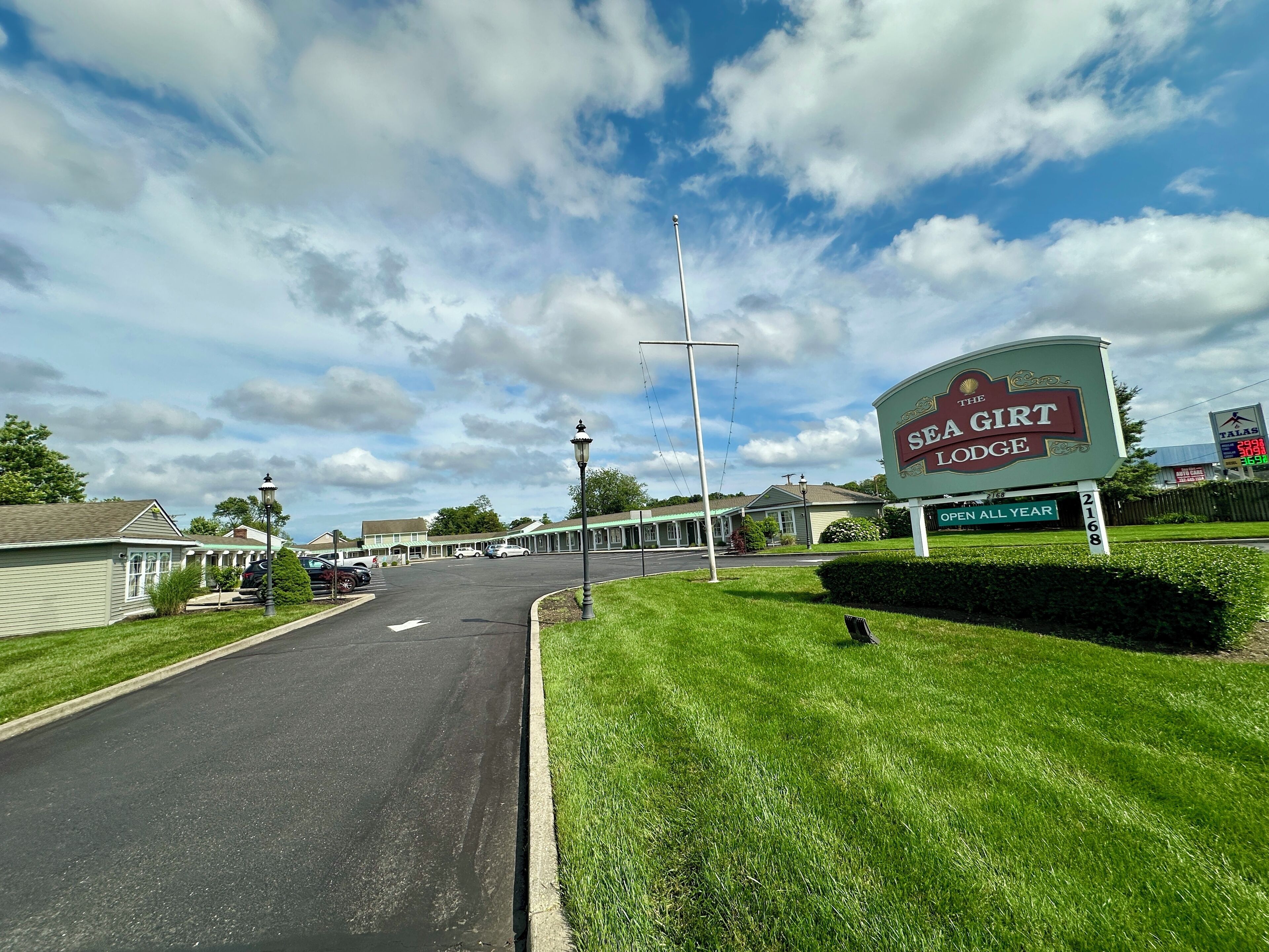 A motel named "The Sea Girl Lodge" with a sign indicating it is open all year.