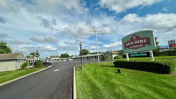 A motel named "The Sea Girl Lodge" with a sign indicating it is open all year.