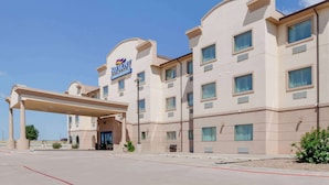 Un hotel con un llamativo letrero de 'Baymont', varios balcones y un acceso cubierto.