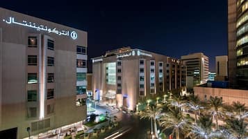 A hotel with a modern facade, multiple floors, and a well-lit entrance area.