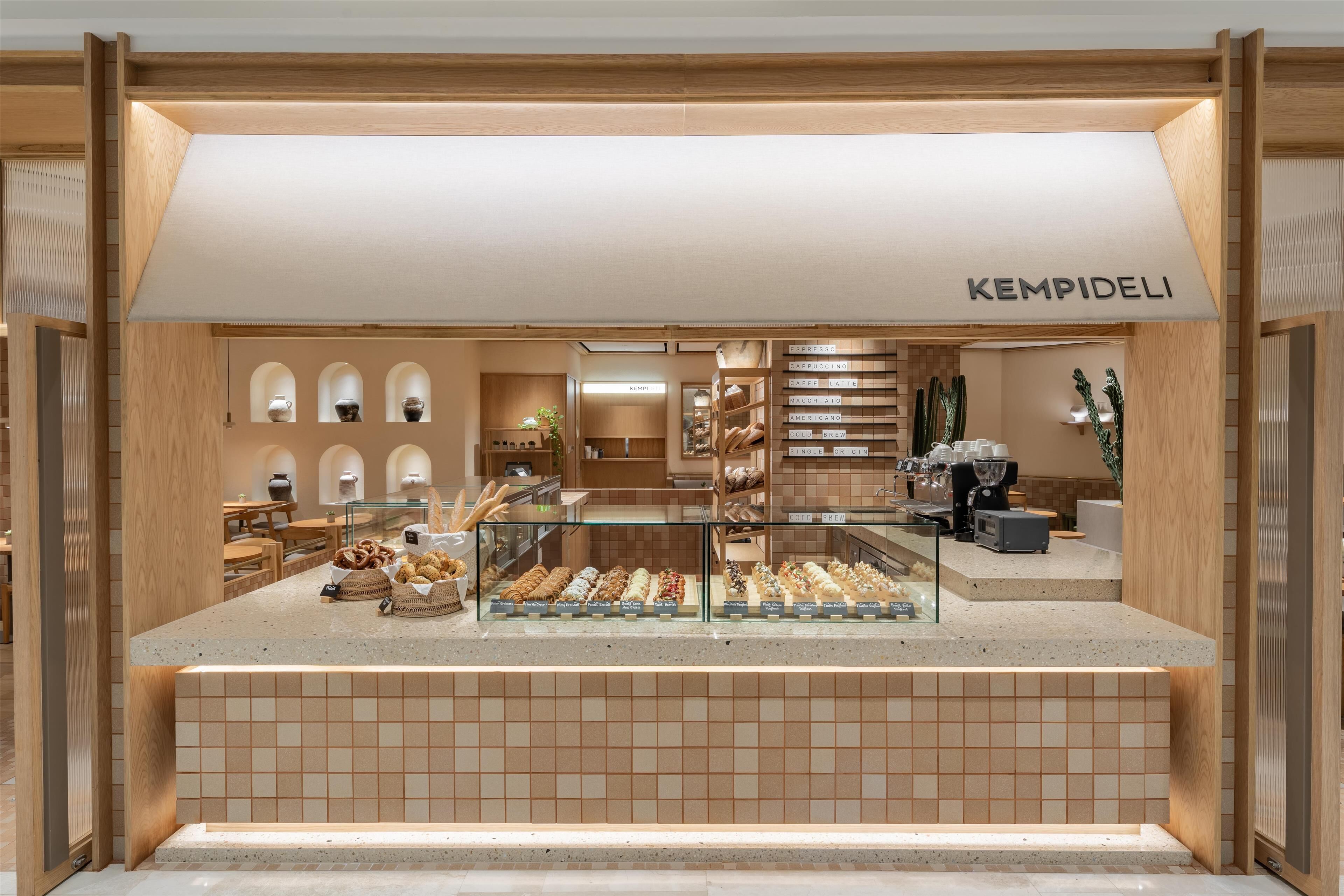 A bakery display with various baked goods and a coffee machine.