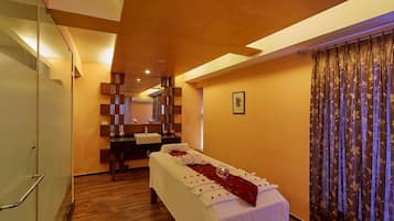 Relax in a spacious room with a large bed, bedside table, and mirror.