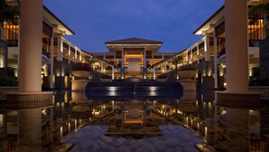 A hotel lobby with a central fountain, multiple floors, and a pool area. - Banyan Tree Sanya (Sanya)