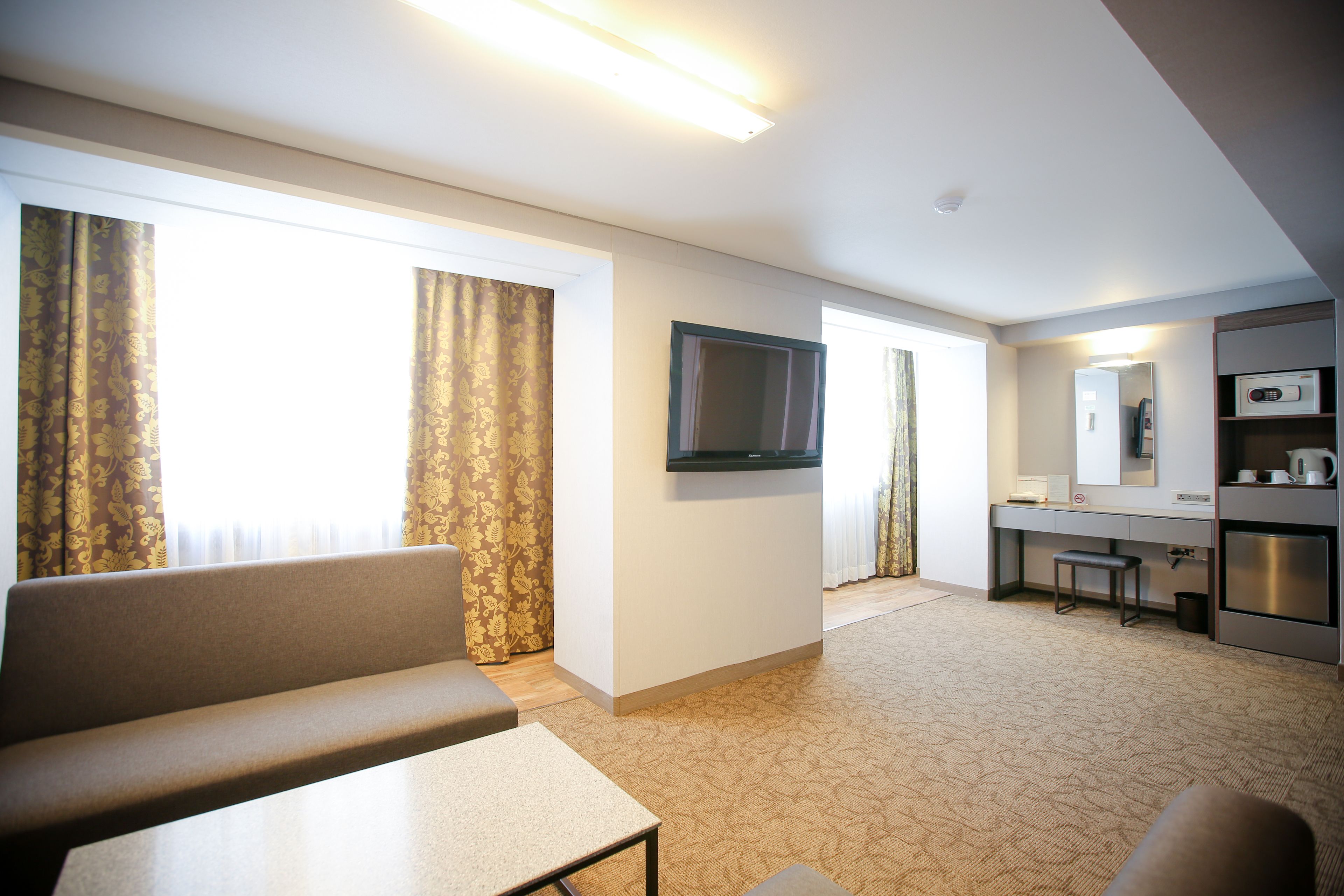 family suite (no parking, additional fee occurs if number of people booked & staying are different) | living area | lcd tv