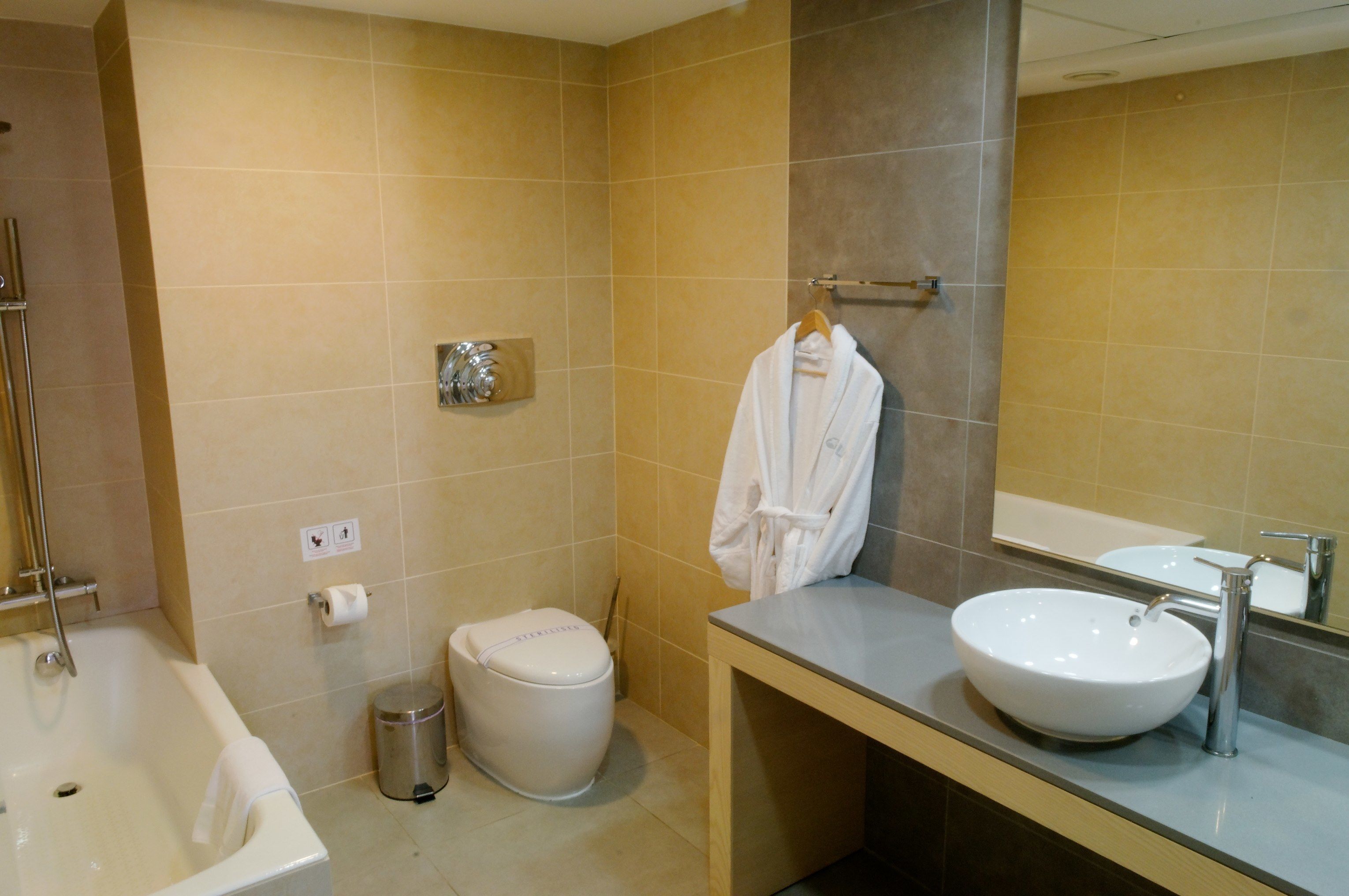 A bathroom with a bathtub, toilet, and sink.