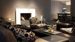 Una sala de estar moderna con chimenea, muebles con diseños y una estética minimalista.