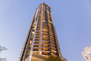 A tall, modern high-rise building with multiple balconies and a clear sky. - Mantra On Mary (Brisbane)