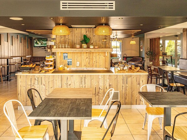 A restaurant with wooden decor, a central counter, and seating arrangements.