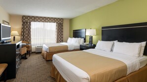 A hotel room with two beds, a desk, a chair, a TV, and a window with curtains. - Holiday Inn Statesboro-University Area by IHG (Statesboro)