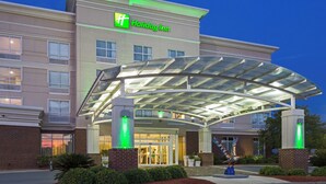A Holiday Inn hotel with a covered entrance, multiple windows, and a brick facade. - Holiday Inn Statesboro-University Area by IHG (Statesboro)