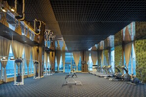 A gym with exercise equipment, large windows, and a patterned floor. - Holiday Inn Chengdu Century City-EastTower by IHG (Chengdu)