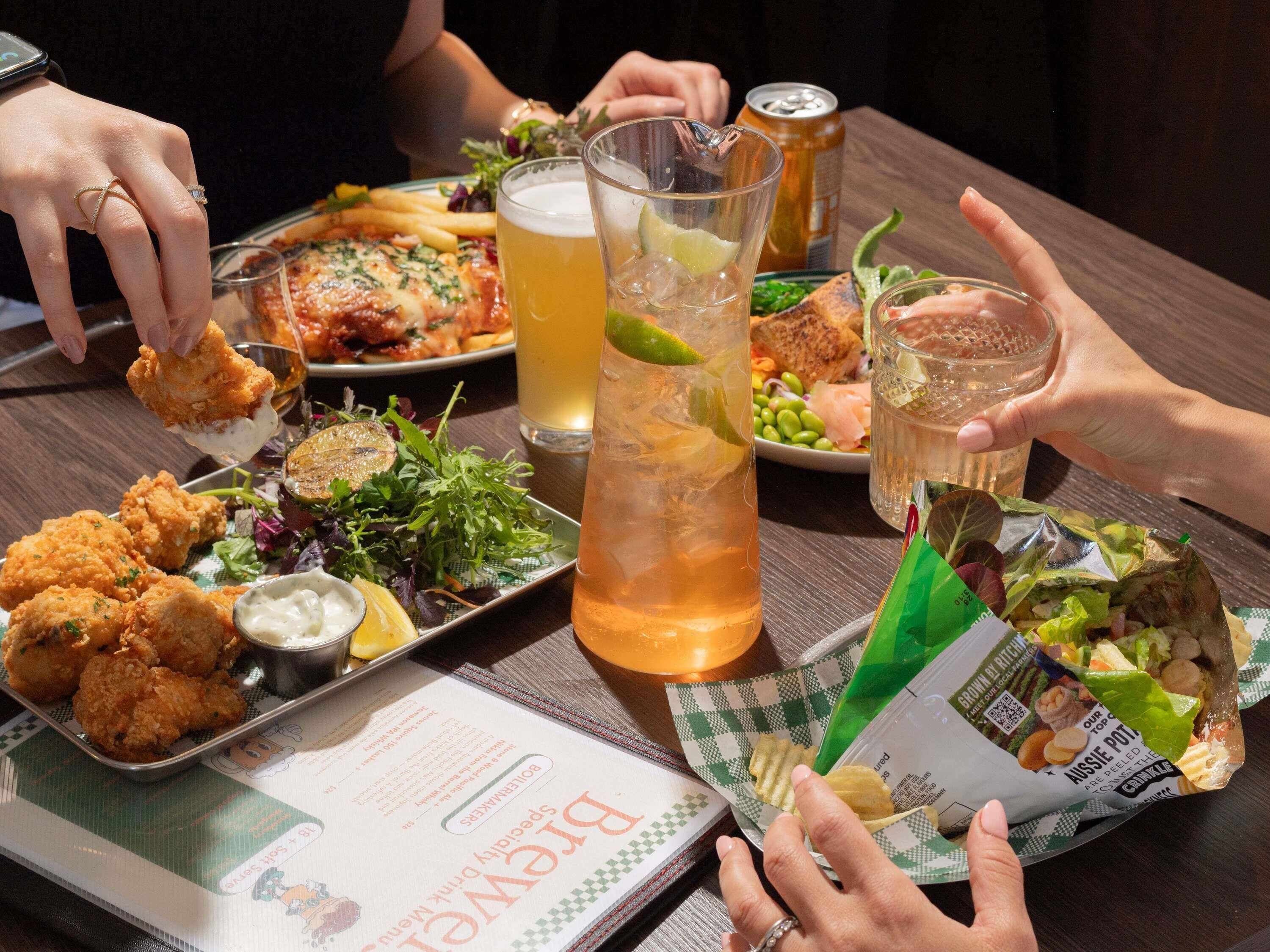 A table with food, drinks, and a menu.