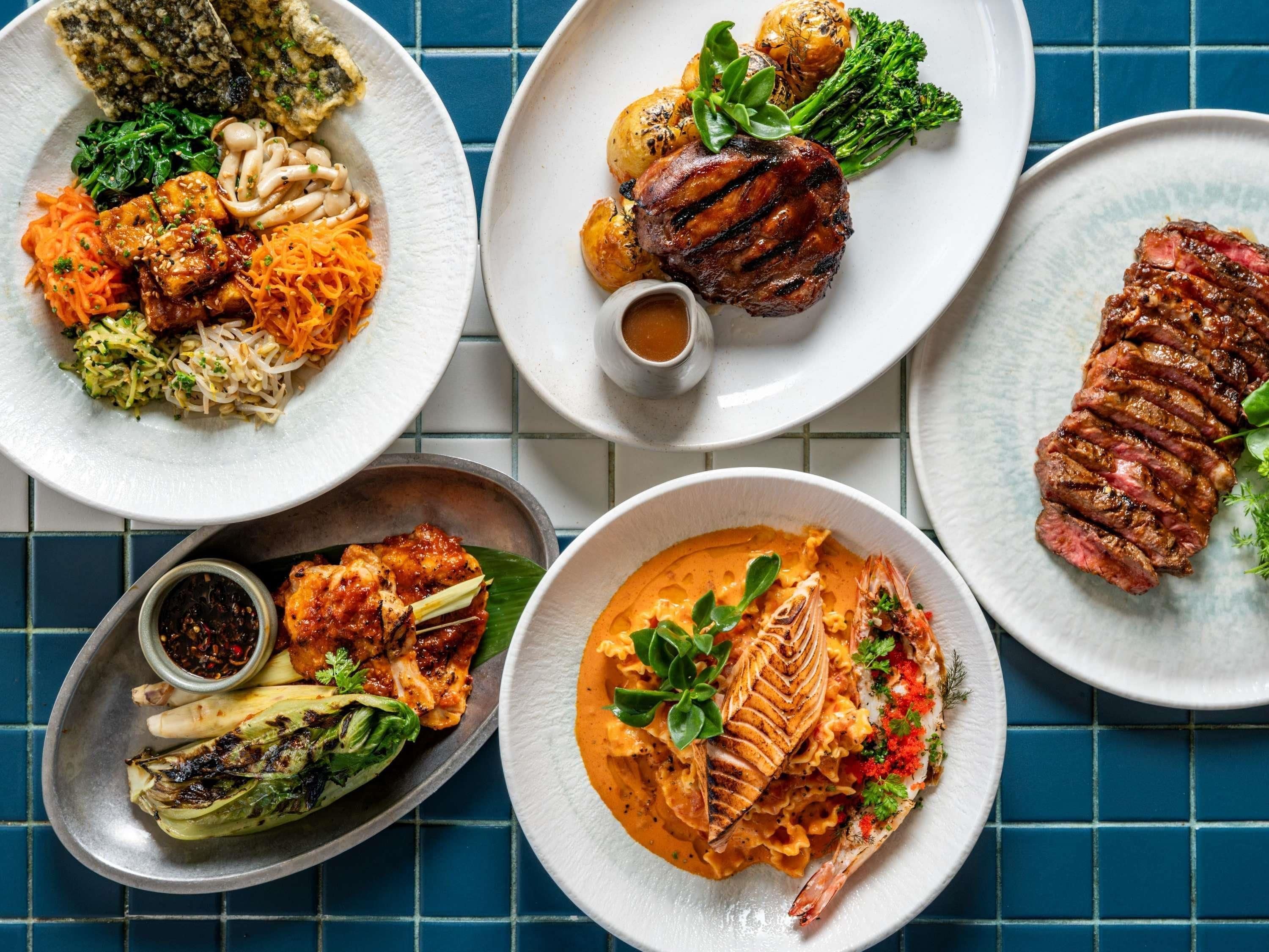 A variety of dishes on a tiled table.