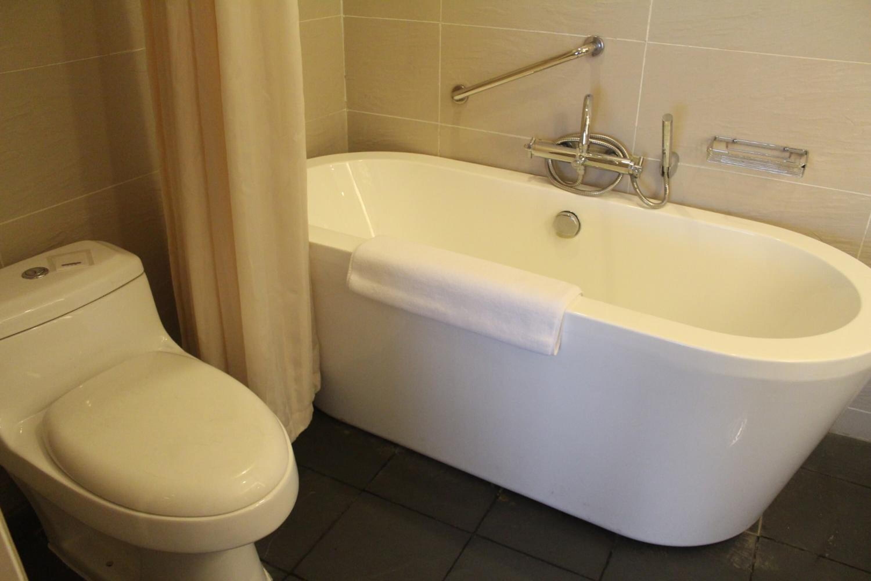 separate bathtub and shower, deep-soaking bathtub, rainfall showerhead