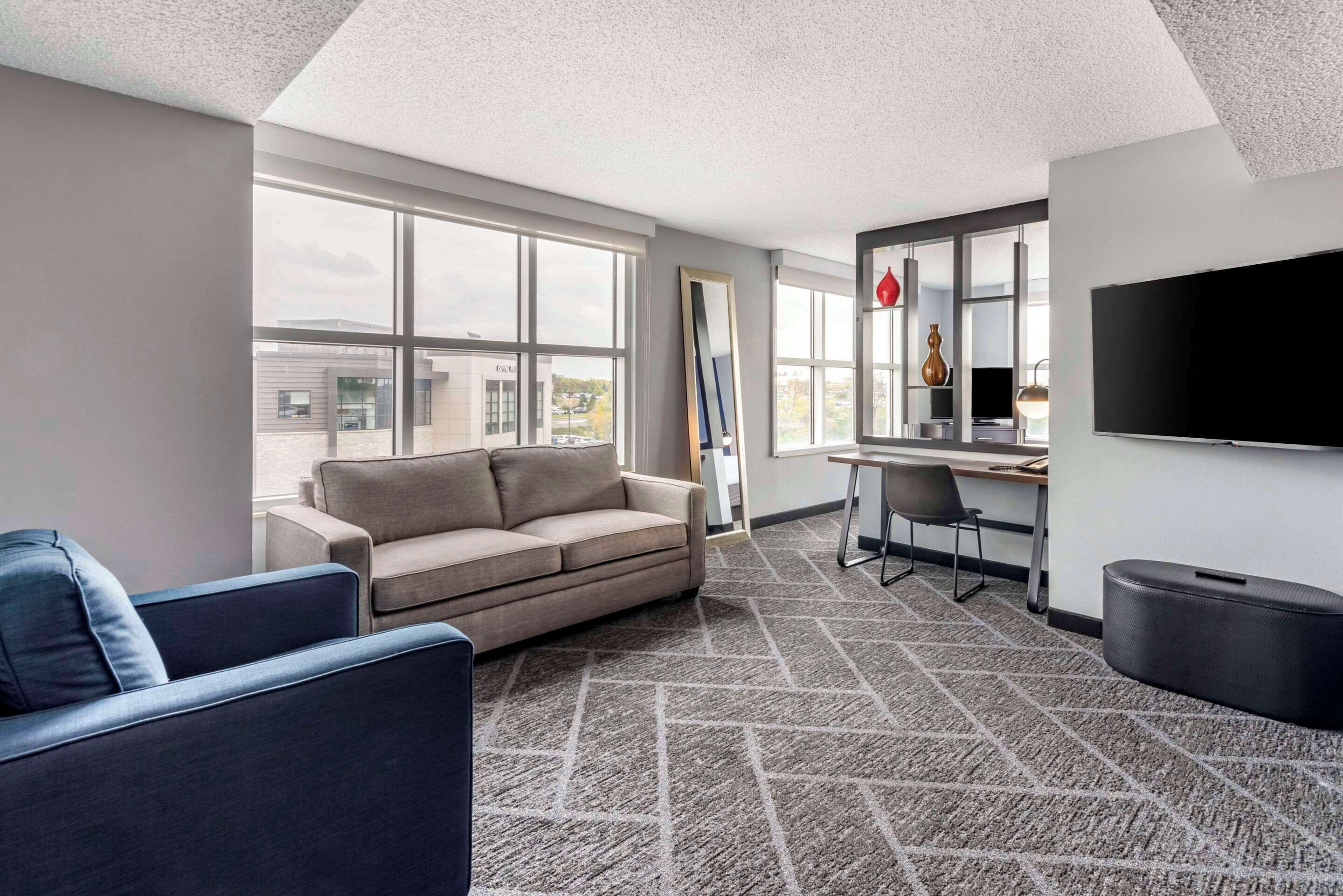 Premium bedding, desk, laptop workspace, blackout drapes