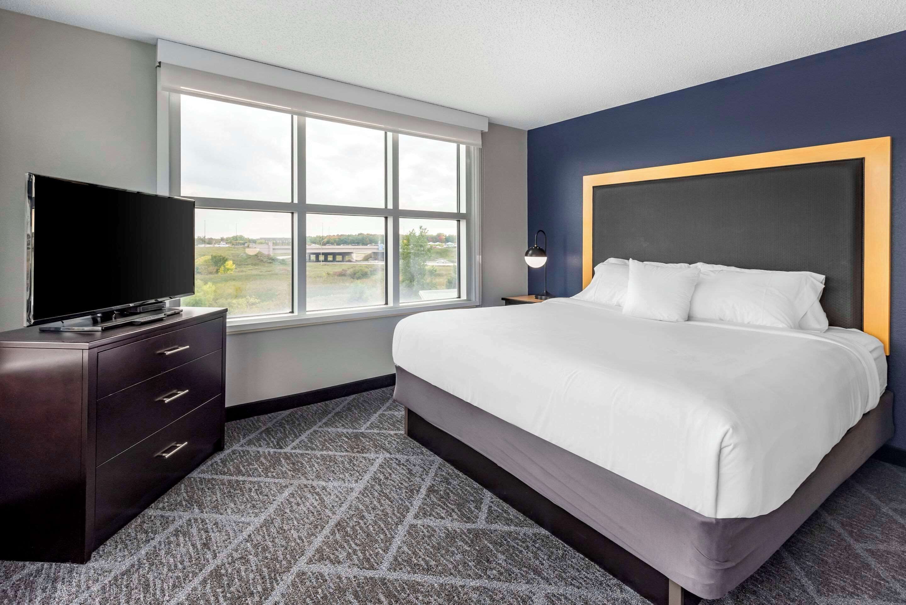 premium bedding, desk, laptop workspace, blackout curtains